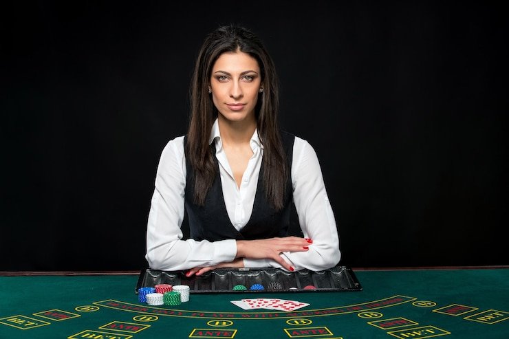 Live dealer revealing community cards in Casino Hold'em